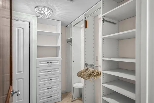 a view of walk in closet with empty racks