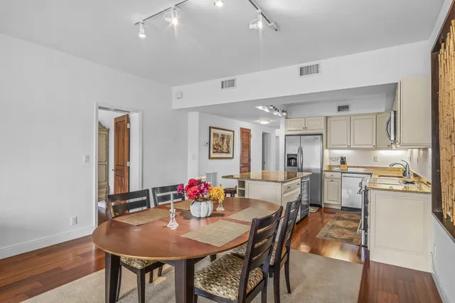 a view of a dining room with furniture and wooden floor