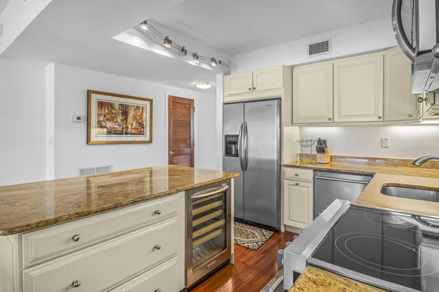 a kitchen with a refrigerator stove and sink