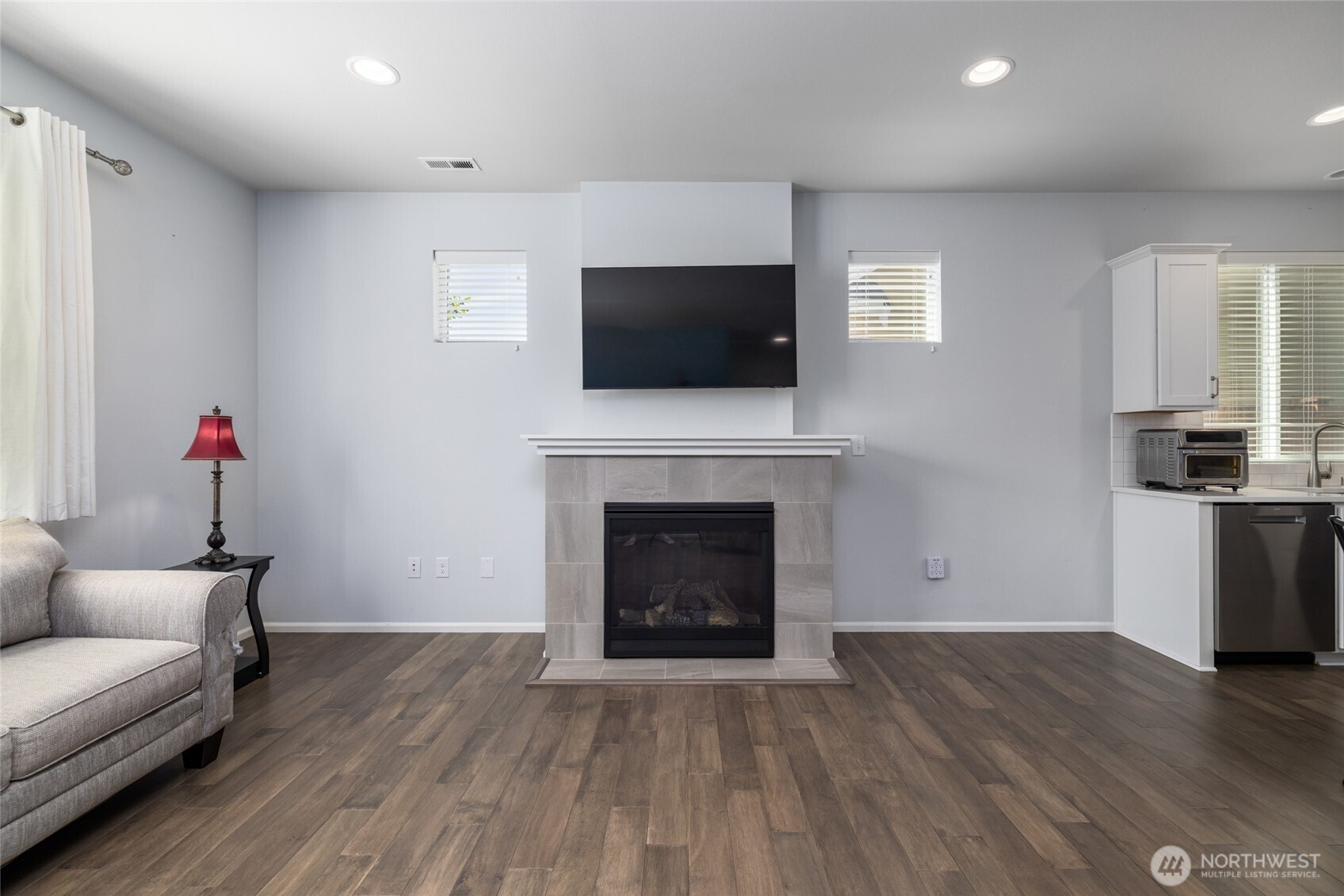 232 Sinclair Alley Mount Vernon, WA 98274 - Photo 6 of 33 a living room with furniture a flat screen tv and a fireplace