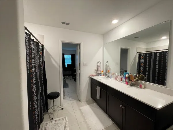 a bathroom with a sink vanity and a mirror