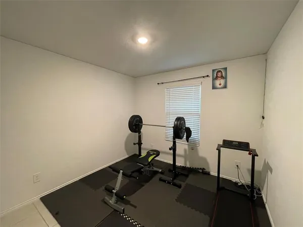 a room with gym equipment and a mirror