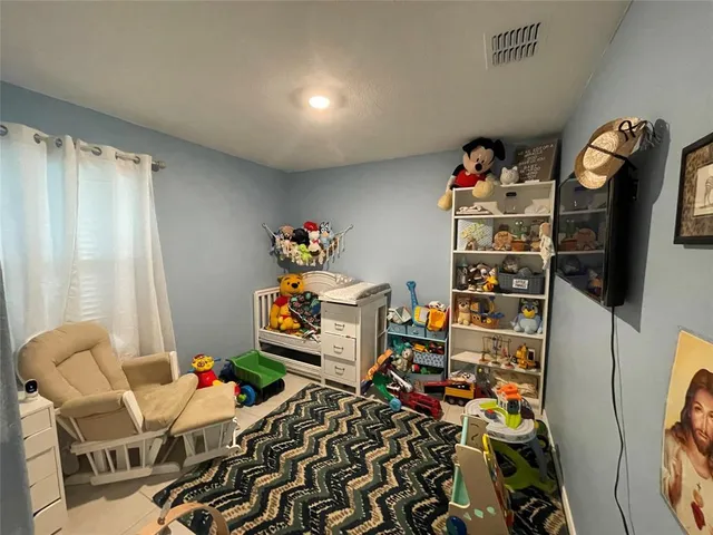 a room with furniture a rug and a window