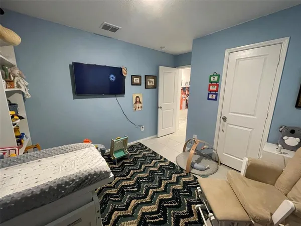 a bedroom with a bed and a couch