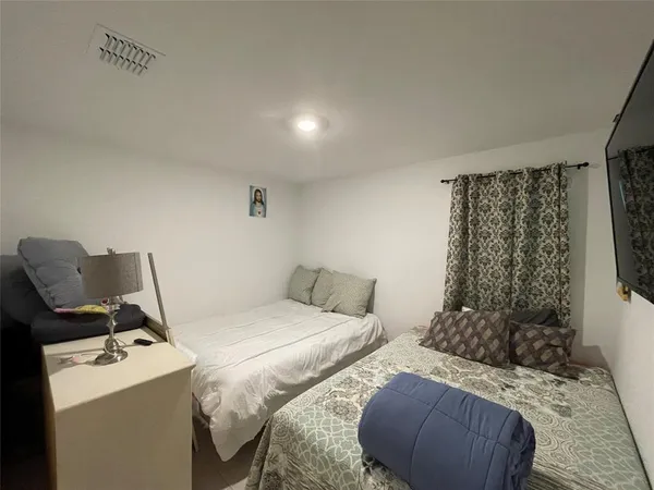 a bedroom with a bed and a chair