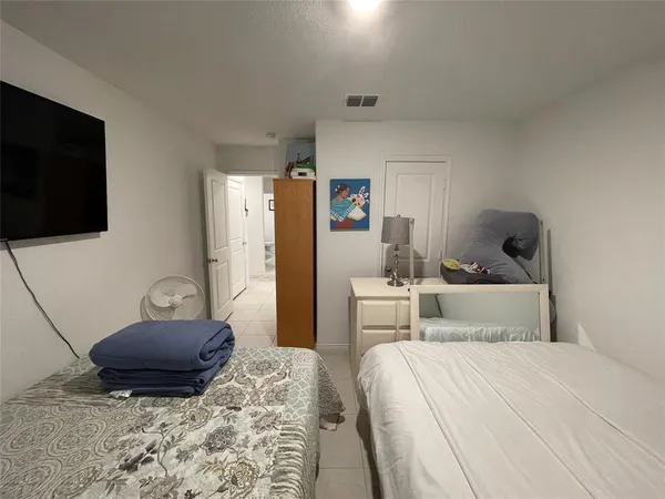 a bedroom with a bed and a television