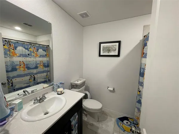 a bathroom with a sink mirror and toilet