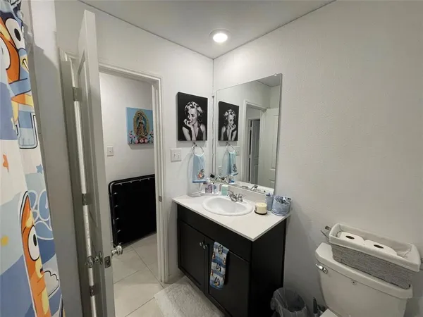 a bathroom with a sink vanity and a toilet