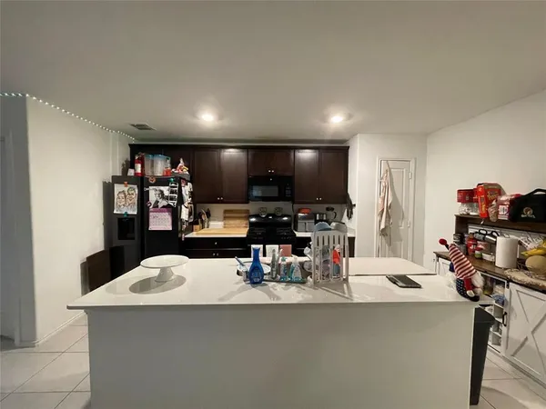 a kitchen with a table and chairs