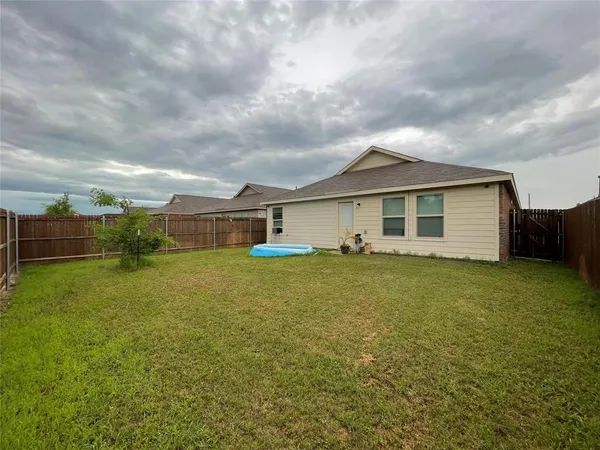 a view of a house with a backyard