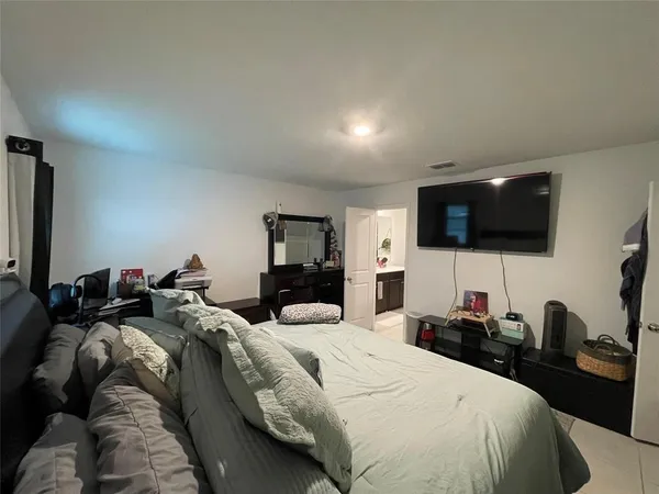 a bed room with a bed a television