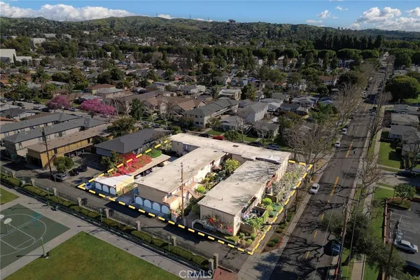 an aerial view of residential houses with outdoor space