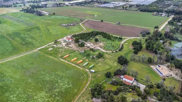 an aerial view of a house with a yard lake lake view and mountain view in back