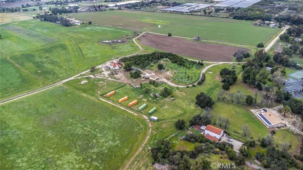 an aerial view of a house with a yard lake lake view and mountain view in back