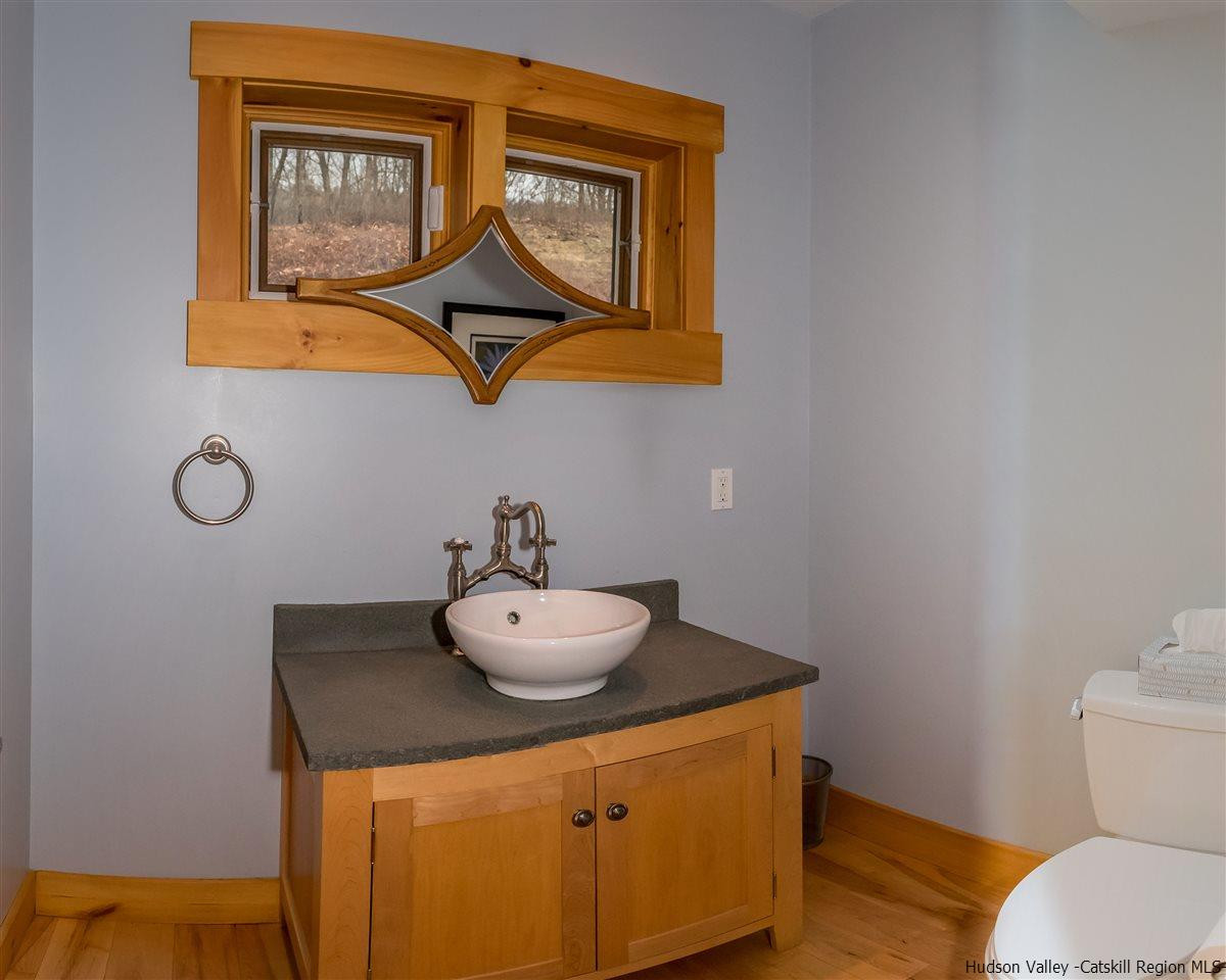 11 Sparkling Ridge Road New Paltz, NY 12561 - Photo 21 of 34 a bathroom with a toilet sink and mirror