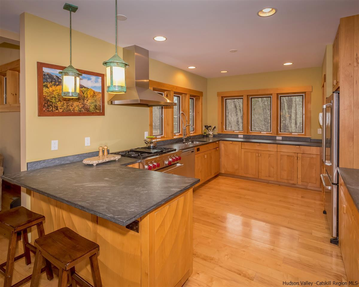 11 Sparkling Ridge Road New Paltz, NY 12561 - Photo 6 of 34 a view of a kitchen with kitchen island a large counter top space a sink stainless steel appliances and cabinets