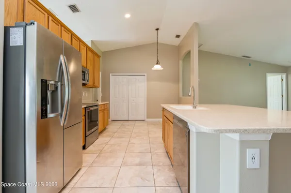 a kitchen with stainless steel appliances a refrigerator and a sink