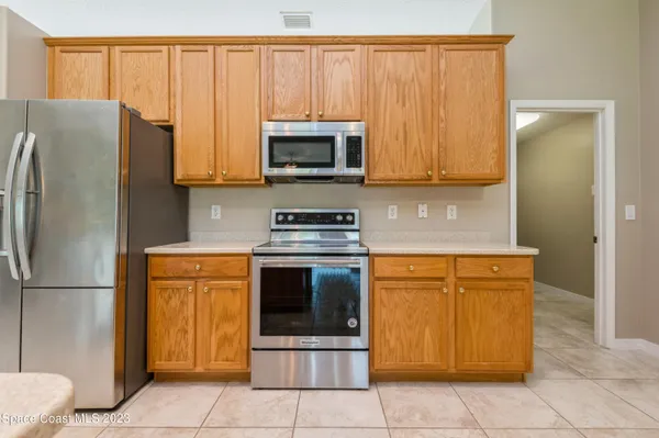 a kitchen with stainless steel appliances granite countertop a refrigerator stove and microwave