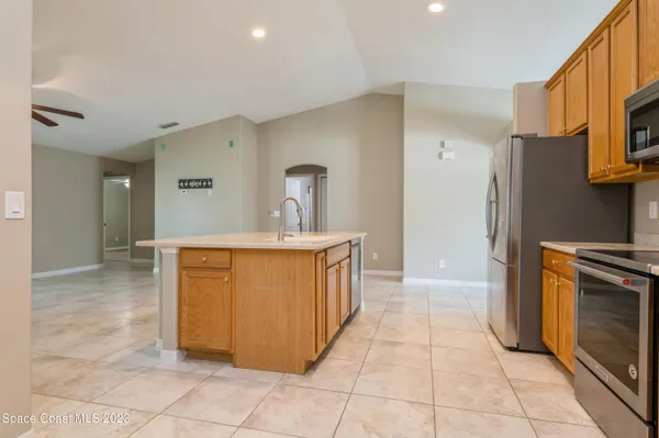 a kitchen with stainless steel appliances a sink and a refrigerator