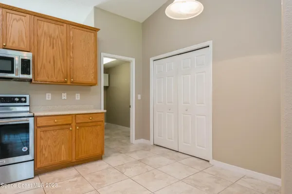 a view of a kitchen with microwave and cabinets