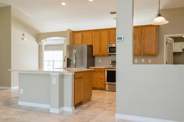 a kitchen with stainless steel appliances a sink and a refrigerator