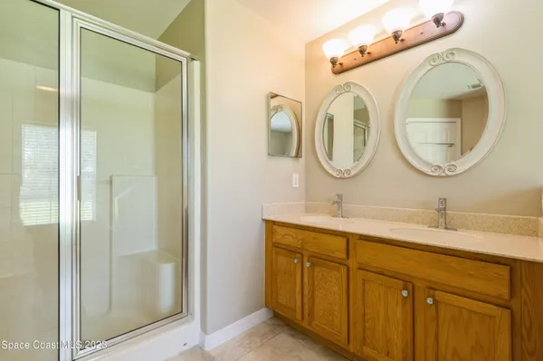 a bathroom with a granite countertop toilet sink and mirror