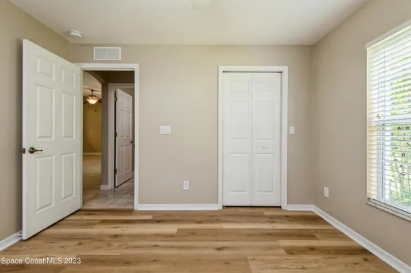 a view of a livingroom with wooden floor and window