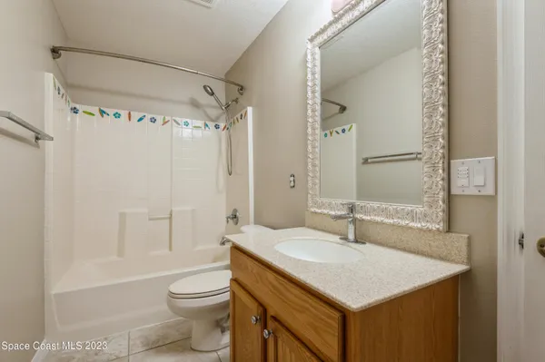 a bathroom with a sink toilet vanity and shower