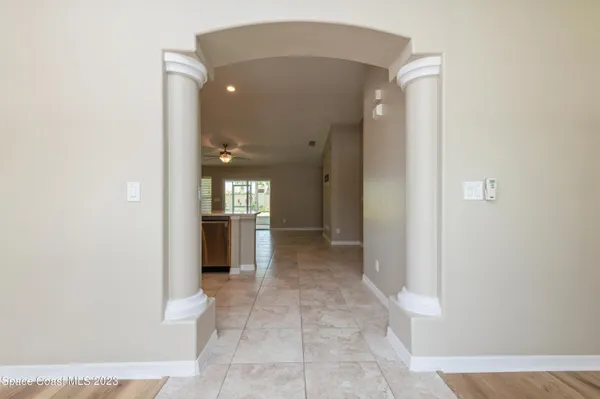 a view of a hallway with wooden shelves