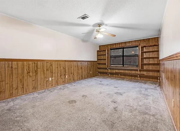 a view of an empty room with a fireplace