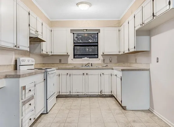 a kitchen with granite countertop a sink and cabinets