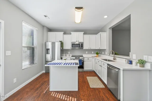 a view of a room with wooden floor and windows