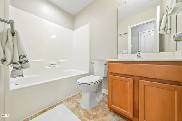 a bathroom with a sink a mirror and a toilet