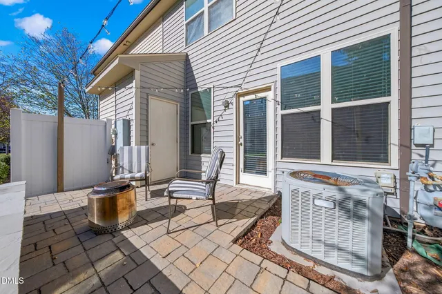 a balcony with table and chairs