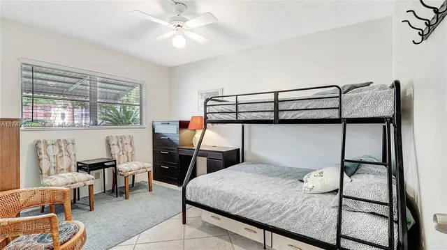 a bedroom with a bed a table and chair