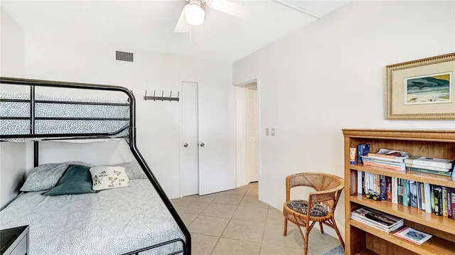a view of a livingroom with furniture and book shelf