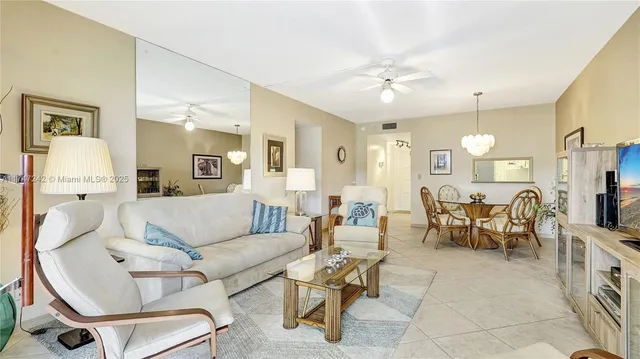 a living room with furniture a dining table and chairs