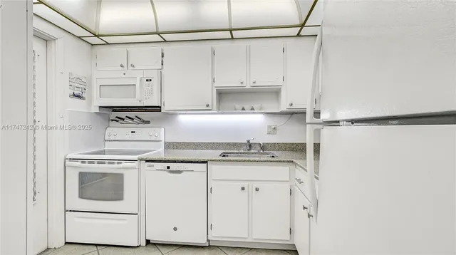 a kitchen with stainless steel appliances granite countertop cabinets and a stove