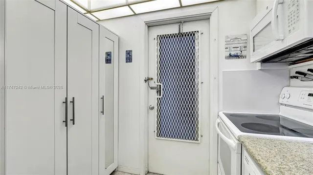 a kitchen with a refrigerator and cabinets