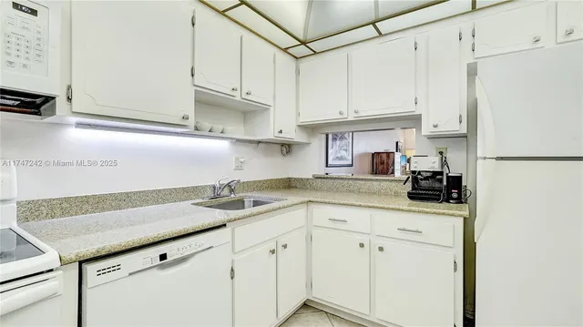 a kitchen with stainless steel appliances granite countertop a sink and cabinets