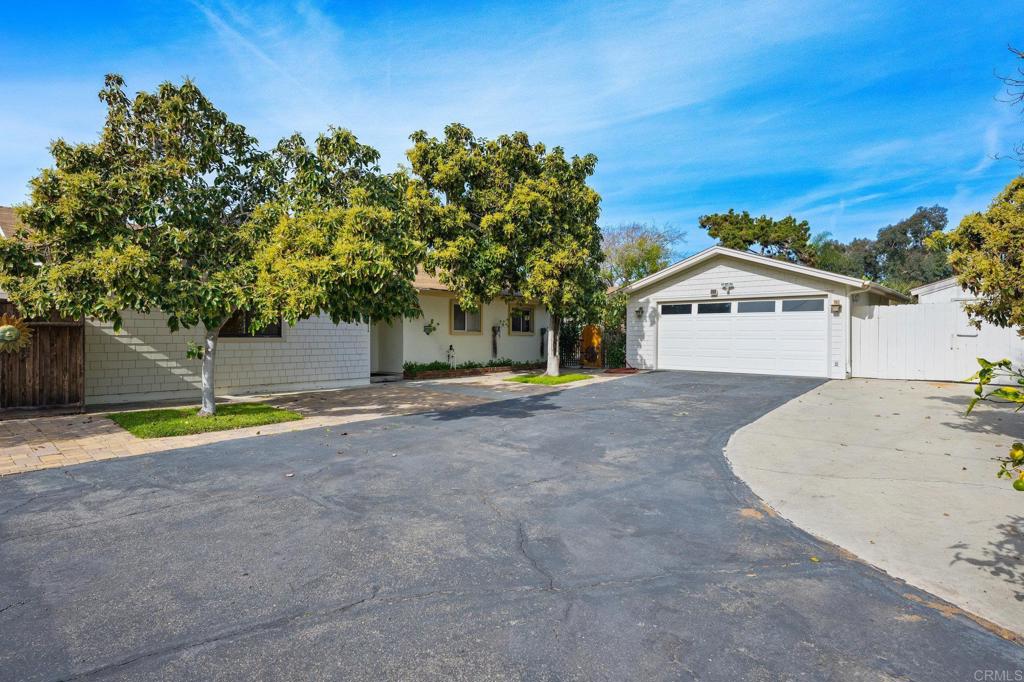 1054 Hermes Avenue Encinitas, CA 92024 - Photo 4 of 37 a view of a house with a backyard and a tree