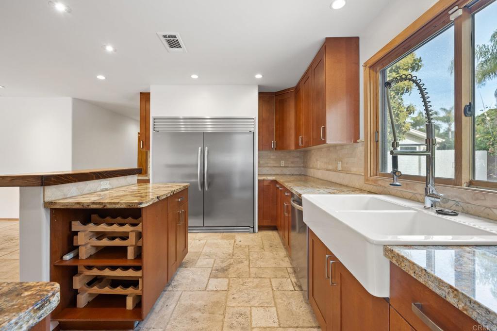 1054 Hermes Avenue Encinitas, CA 92024 - Photo 8 of 37 a kitchen with stainless steel appliances granite countertop a sink and a refrigerator