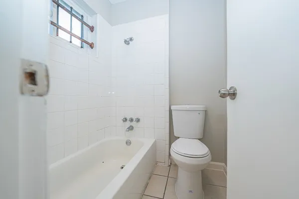 a bathroom with a toilet and a bathtub