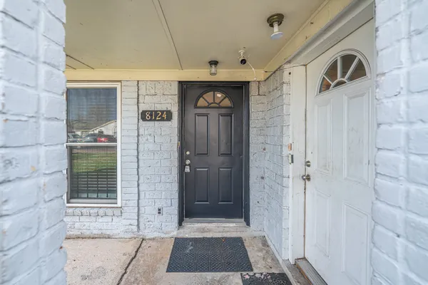 a view of a entryway door front of a house