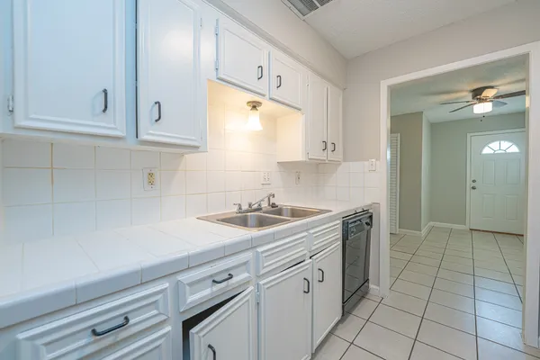 a kitchen with a sink and cabinets