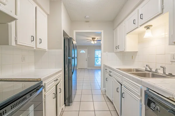 a kitchen with a sink stove and cabinets