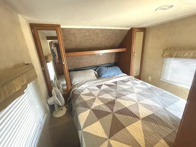 a bedroom with a bed and a window