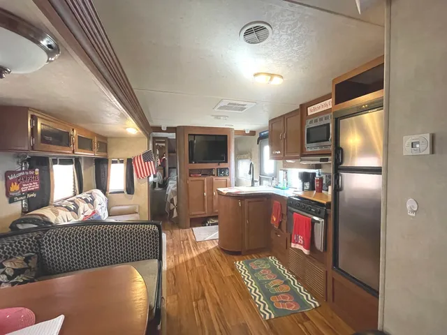 a kitchen with granite countertop lots of clutter and stainless steel appliances