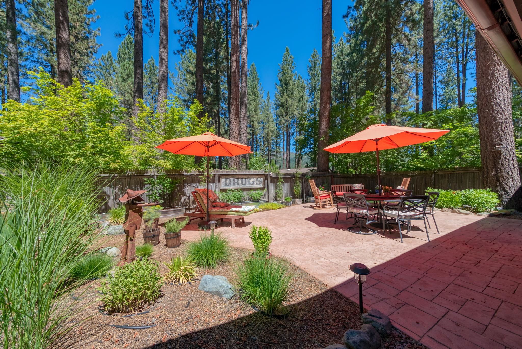 50 Graeagle Meadows Road Graeagle, CA 96103 - Photo 31 of 39 an outdoor space with patio furniture and umbrella