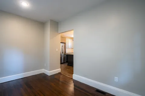 a view of a room with wooden floor